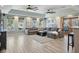 Spacious living room with tray ceilings, ceiling fans, large sectional sofa, and water views from the many windows at 1361 46Th Ne Ave, St Petersburg, FL 33703