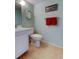 Well-kept bathroom features tiled floor, toilet, vanity and matching fixtures at 14130 Rosemary Ln # 3312, Largo, FL 33774