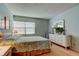 Relaxing bedroom features natural light, a dresser with mirror, and soothing pastel walls at 14130 Rosemary Ln # 3312, Largo, FL 33774