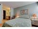 Comfortable bedroom features calming wall colors, carpet, and an ensuite bathroom at 14130 Rosemary Ln # 3312, Largo, FL 33774