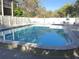 Large community pool with lounge chairs, umbrellas, and a relaxing atmosphere at 14130 Rosemary Ln # 3312, Largo, FL 33774