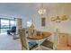 Sun-lit dining area featuring a charming chandelier, wood table and seating for four at 14130 Rosemary Ln # 3312, Largo, FL 33774