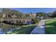 Beautiful complex view with a scenic pond, wooden bridge, walkway, fountain, and lush landscaping at 14130 Rosemary Ln # 3312, Largo, FL 33774