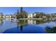 Picturesque view of a complex overlooking a pond, fountain, and greenery at 14130 Rosemary Ln # 3312, Largo, FL 33774