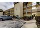 Exterior of a condo building featuring balconies and assigned parking with landscaping at 14130 Rosemary Ln # 3312, Largo, FL 33774