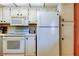 Bright kitchen features white appliances, tile backsplash, and lots of storage at 14130 Rosemary Ln # 3312, Largo, FL 33774