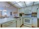 Bright kitchen with countertop seating and modern appliances at 14130 Rosemary Ln # 3312, Largo, FL 33774