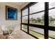 Enclosed lanai with tile floor features a large picture window overlooking the lush landscape at 14130 Rosemary Ln # 3312, Largo, FL 33774