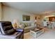Comfortable living area adjacent to dining room with a wall mirror, lamps, and cozy recliners at 14130 Rosemary Ln # 3312, Largo, FL 33774