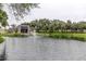 Scenic pond with a fountain, lush greenery, and nearby buildings for a tranquil view at 14130 Rosemary Ln # 3312, Largo, FL 33774