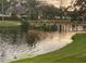 Picturesque view of a pond with a walking bridge, trees, and wildlife at 14130 Rosemary Ln # 3312, Largo, FL 33774