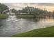 Calm pond featuring a fountain, a bridge and an egret, surrounded by lush landscaping at 14130 Rosemary Ln # 3312, Largo, FL 33774