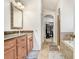 Bathroom featuring granite counters, ample storage, and a view through the arched doorway at 15723 Starling Water Dr, Lithia, FL 33547