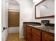 Bathroom features tile flooring, granite countertop vanity, and shower with tub at 15723 Starling Water Dr, Lithia, FL 33547