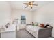 Cozy bedroom features a ceiling fan, daybed, and a large desk for study or creative work at 15723 Starling Water Dr, Lithia, FL 33547