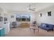 Spacious bonus room featuring a ceiling fan, three windows, two desks, and a comfortable seating area at 15723 Starling Water Dr, Lithia, FL 33547