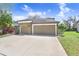 Charming home featuring a well-manicured lawn, and a spacious three car garage at 15723 Starling Water Dr, Lithia, FL 33547