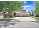 Charming home featuring a well-manicured lawn, mature trees, and a spacious three car garage at 15723 Starling Water Dr, Lithia, FL 33547