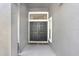 Elegant double front doors are featured with a light gray siding and modern glass fixtures at 15723 Starling Water Dr, Lithia, FL 33547
