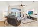 Bright living room features vaulted ceilings, large windows, and a sliding door to the yard at 15723 Starling Water Dr, Lithia, FL 33547