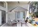 Covered patio features a dining set with an umbrella and outdoor decor at 15723 Starling Water Dr, Lithia, FL 33547