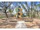 View of the community playground with climbing structure, and slides, set in a wooded area at 15723 Starling Water Dr, Lithia, FL 33547