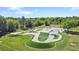 Drone shot of community skatepark featuring ramps, rails, and green spaces for outdoor recreation at 15723 Starling Water Dr, Lithia, FL 33547