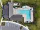 Overhead shot of community pool and clubhouse, featuring a unique design and ample parking at 16822 Balance Cv, Land O Lakes, FL 34638