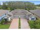 Charming single-Gathering home featuring a paved driveway, a two-car garage and lush landscaping at 16822 Balance Cv, Land O Lakes, FL 34638