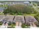 Charming single-Gathering home featuring a paved driveway, a two-car garage and lush landscaping near a pond and wooded area at 16822 Balance Cv, Land O Lakes, FL 34638