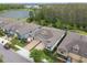 Charming single-Gathering home featuring a paved driveway, a two-car garage and lush landscaping near a pond at 16822 Balance Cv, Land O Lakes, FL 34638