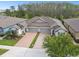 Charming single-Gathering home featuring a paved driveway, a two-car garage and lush landscaping at 16822 Balance Cv, Land O Lakes, FL 34638