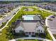 An aerial view showcasing the community's clubhouse, pool, playground, and green spaces at 16822 Balance Cv, Land O Lakes, FL 34638