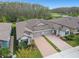 Charming single-Gathering home featuring a paved driveway, a two-car garage and lush landscaping at 16822 Balance Cv, Land O Lakes, FL 34638