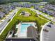 An aerial view of the community featuring a pool, clubhouse, playground, and well-maintained landscaping at 16822 Balance Cv, Land O Lakes, FL 34638