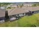 Aerial view showing a home's backyard with screened patios and green lawn at 16822 Balance Cv, Land O Lakes, FL 34638