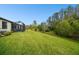Well-maintained backyard featuring a lush green lawn and a screened-in patio, perfect for outdoor enjoyment at 16822 Balance Cv, Land O Lakes, FL 34638