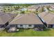 Aerial shot of a home with a well-maintained lawn and screened-in patio at 16822 Balance Cv, Land O Lakes, FL 34638