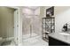 Modern bathroom with a glass-enclosed shower and decorative shelving at 16822 Balance Cv, Land O Lakes, FL 34638