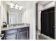 Neutral bathroom with granite countertop, dark wood cabinets, and shower-tub combo at 16822 Balance Cv, Land O Lakes, FL 34638