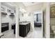 Bright bathroom featuring dual vanities, modern lighting, and access to the walk-in closet at 16822 Balance Cv, Land O Lakes, FL 34638