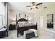 Bright primary bedroom showcases a four-poster bed, and lots of natural light at 16822 Balance Cv, Land O Lakes, FL 34638