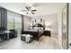 Spacious primary bedroom with a four-poster bed and a cozy sitting area at 16822 Balance Cv, Land O Lakes, FL 34638