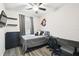 Well-lit bedroom features modern gray flooring and a ceiling fan for added comfort at 16822 Balance Cv, Land O Lakes, FL 34638