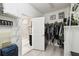Open walk-in closet with shelving leading to a bright bathroom at 16822 Balance Cv, Land O Lakes, FL 34638