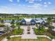 Aerial view of a community clubhouse with a lake view and manicured landscaping at 16822 Balance Cv, Land O Lakes, FL 34638