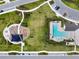 Aerial view of the community playground, pool, and parking, offering many amenities for residents at 16822 Balance Cv, Land O Lakes, FL 34638