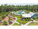 Aerial view of a community featuring a pool, playground, clubhouse, and manicured landscaping at 16822 Balance Cv, Land O Lakes, FL 34638