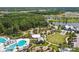 Aerial view of community amenities, including the pool, clubhouse, fire pit, and playground at 16822 Balance Cv, Land O Lakes, FL 34638