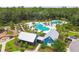 Aerial view of community amenities including a pool, clubhouse, playground, and manicured landscaping at 16822 Balance Cv, Land O Lakes, FL 34638